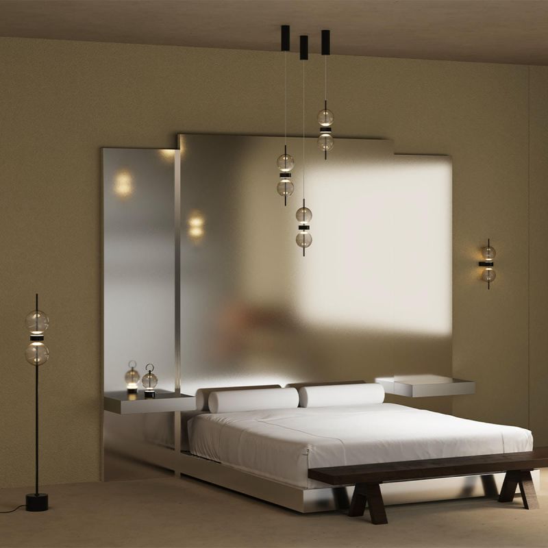 Several Double Moon pendant lights above a bed, wall lights and a floor lamp