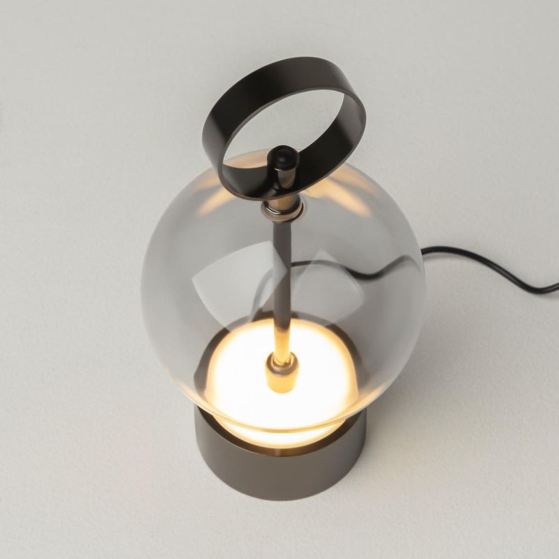 Preview: Side view of the cordless lamp with glowing glass ball, grey base and black cable