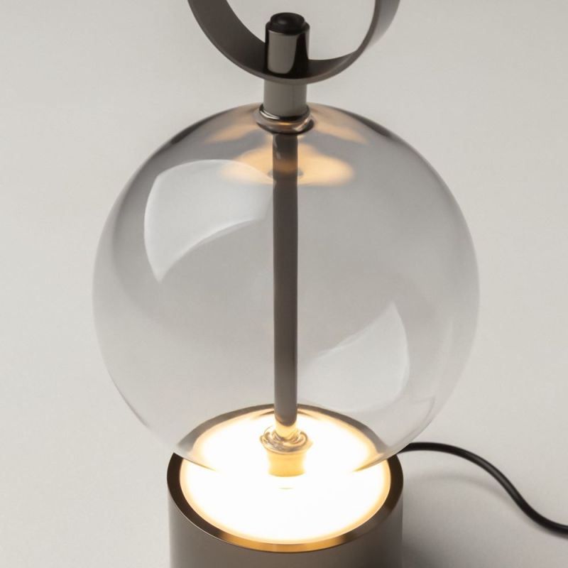 Preview: Cordless table lamp with a glass ball on a grey round base and black ring handle on top
