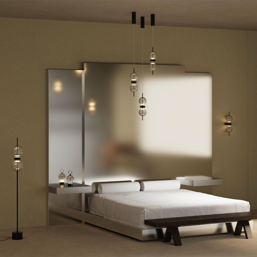 Several Double Moon pendant lights above a bed, wall lights and a floor lamp
