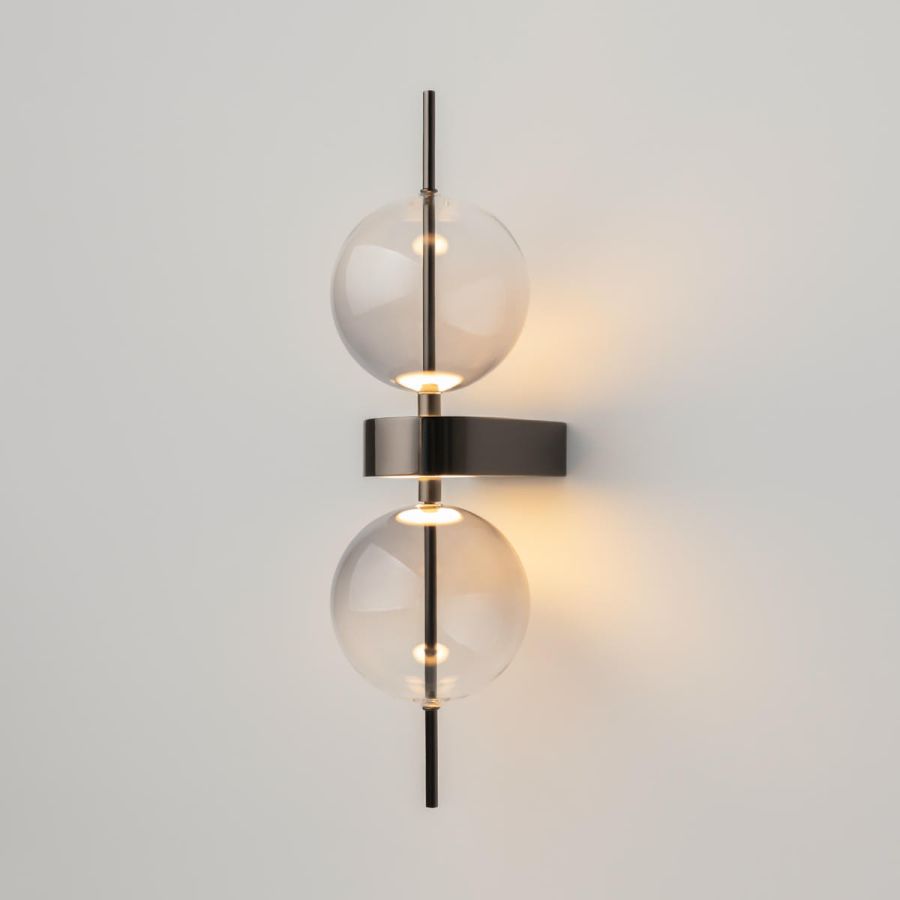 Design wall light, black, with two glass globes, warm white glow, side view
